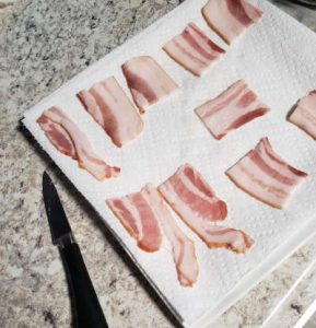 cut bacon on paper towel lined plate