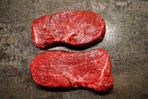 two raw steaks