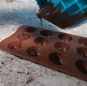 pouring dark chocolate into mold