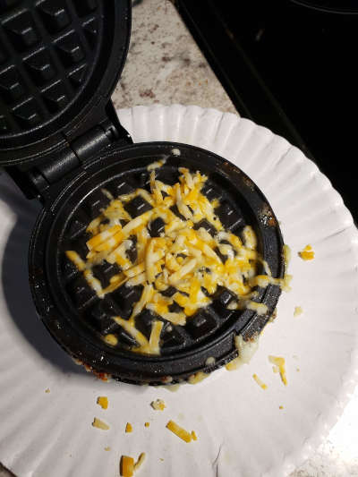 shredded cheese in the waffle maker for a crispy texture