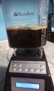Hot coffee, unsalted butter, and MCT oil in blender before blending.