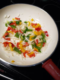 Simmer onions and bell pepper in butter and spices for added flavor in your easy keto chicken stir fry.